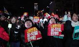 Protesters hold banners in Seoul on Saturday calling for the ouster of South Korean President Yoon Suk-yeol.