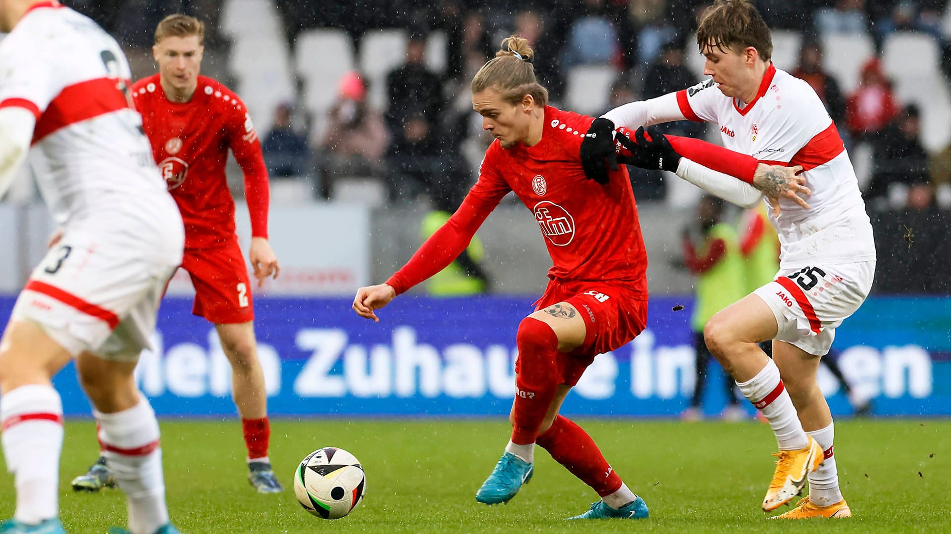 Players in a duel during the game between Essen and Stuttgart's U23: Before the game there was a border crossing in the stands.