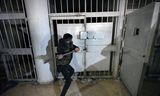 A man breaks a lock in the infamous Saydnaya prison, 30 kilometers north of Damascus. On Monday December 9. 