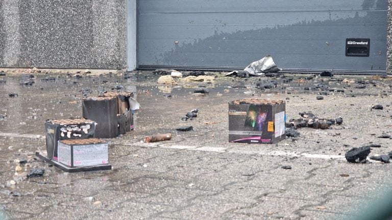 Many fireworks remains near the building that has partly burned out (photo: Noël van Hooft).