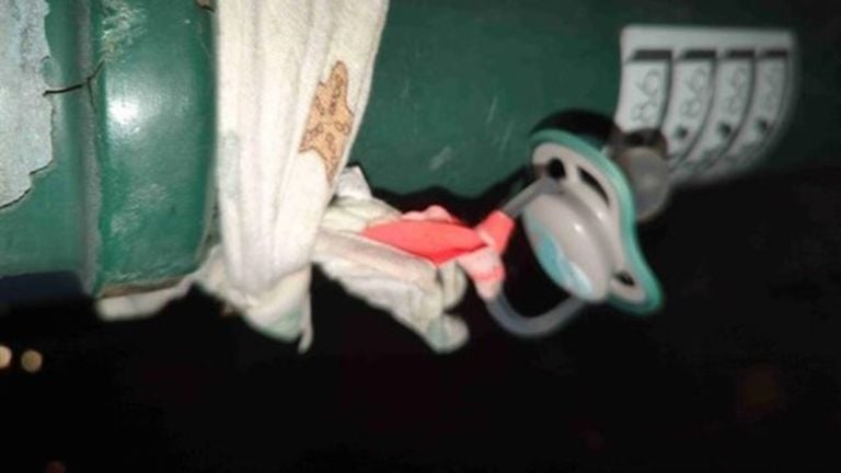 A found pacifier tied to a post. 