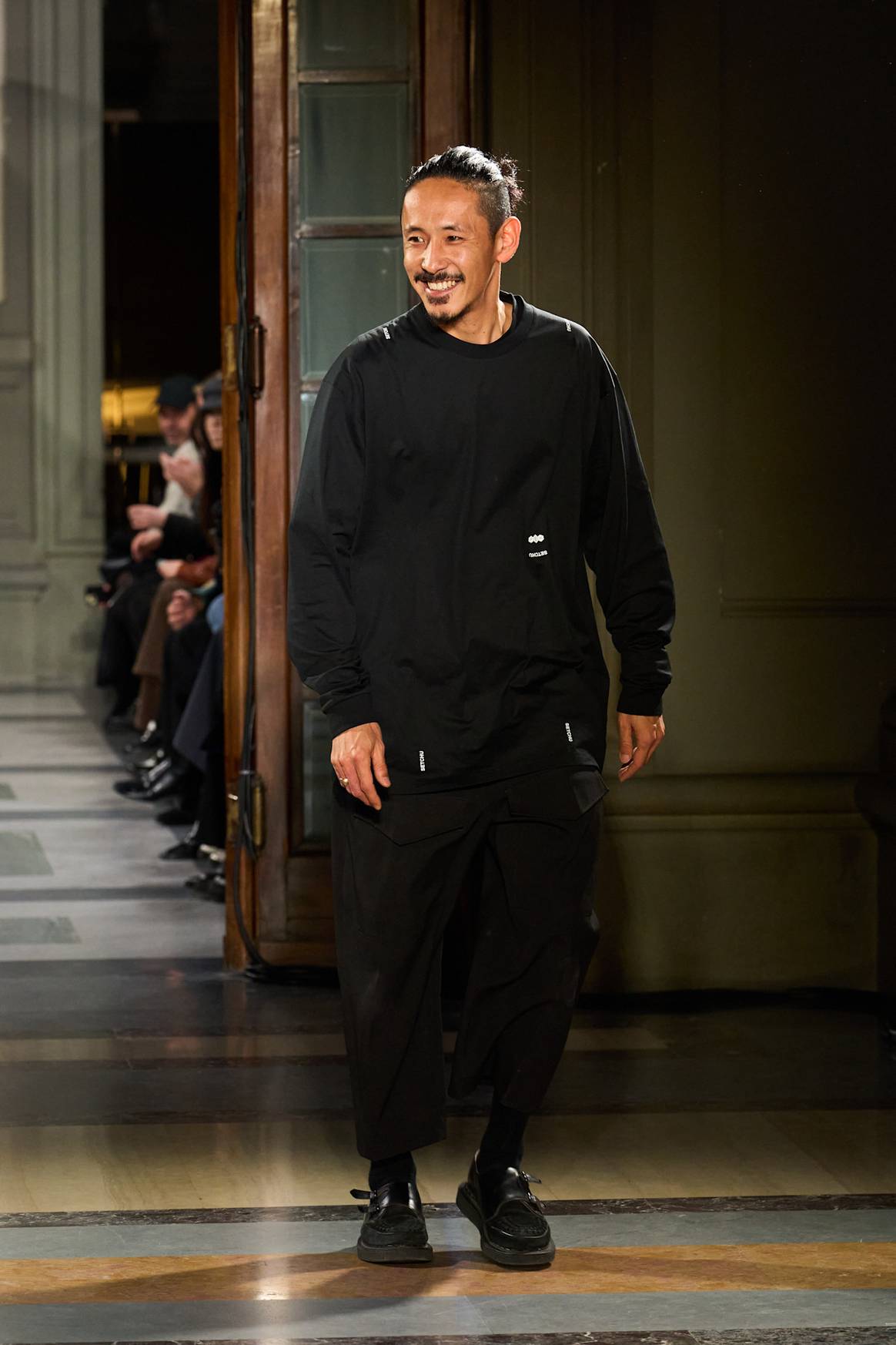 Designer Satoshi Kuwata at the finale of the Setchu FW25 Pitti show.
