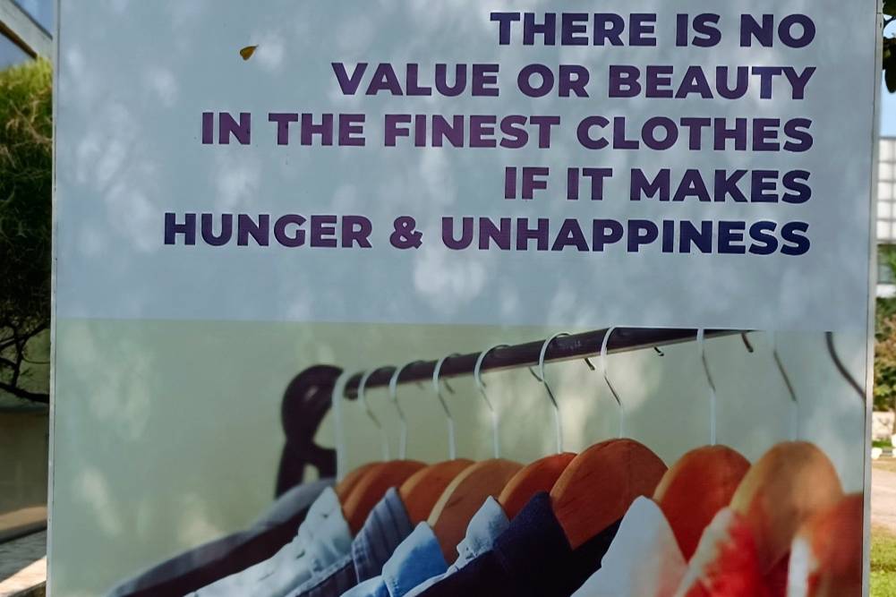 “There is no value or beauty in the finest clothes if they cause hunger and unhappiness.” Poster at Made in Bangladesh Week, Dhaka. Photo: Sumit Suryawanshi for FashionUnited