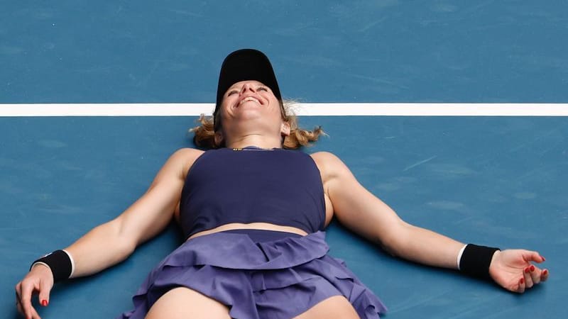 Done: Laura Siegemund cheers and lies on the floor.
