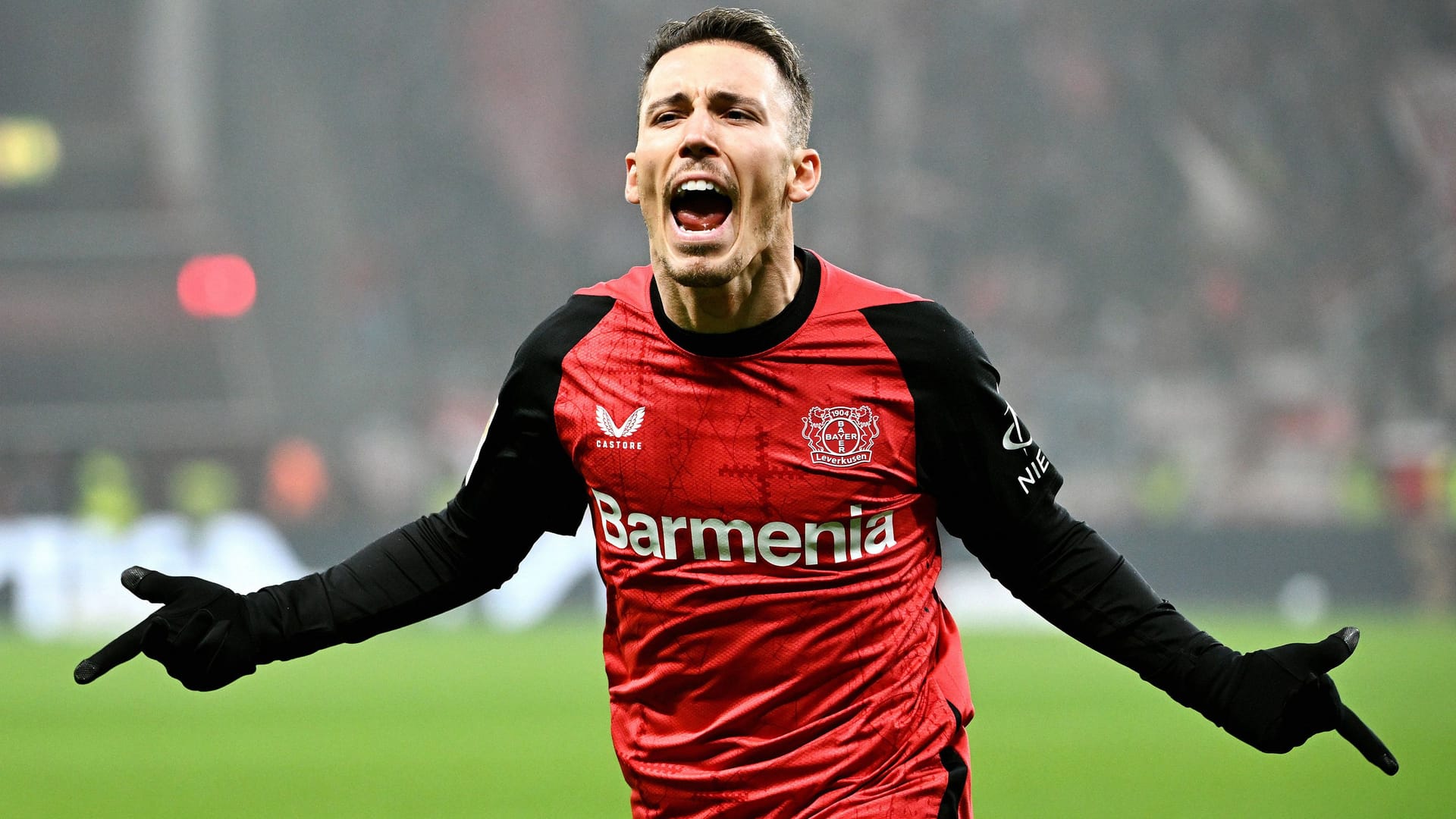 Match winner: Leverkusen's Alejandro Grimaldo celebrates his goal against Mainz 05.