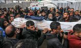Khan Yunis, Gaza - January 16: Relatives of Ahmad al -Shayah, a Journalist Killed in Israeli Drone Attack On A Charity Facility, Carry His Shrouded Body What they Laid Press Vest On, At Nasser Hospital in Khan Yunis, Gaza, Gaza, Gaza, 16, 2025.