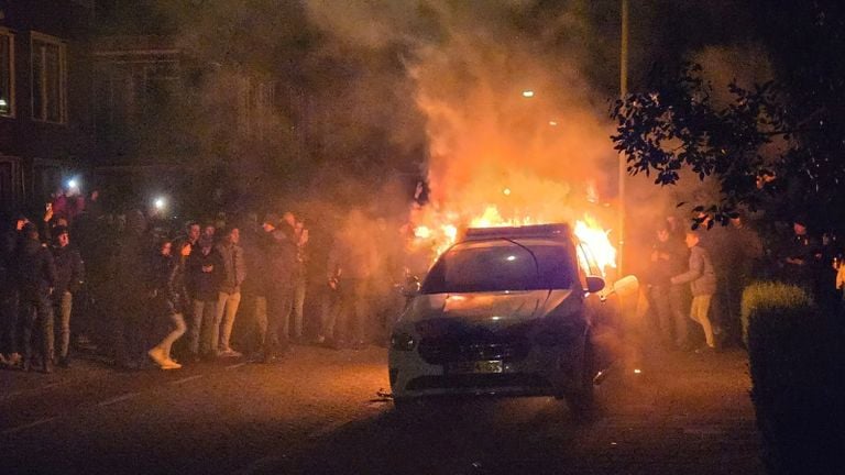 The police car was soon ablaze with dozens of people surrounding it (photo: SQ Vision).