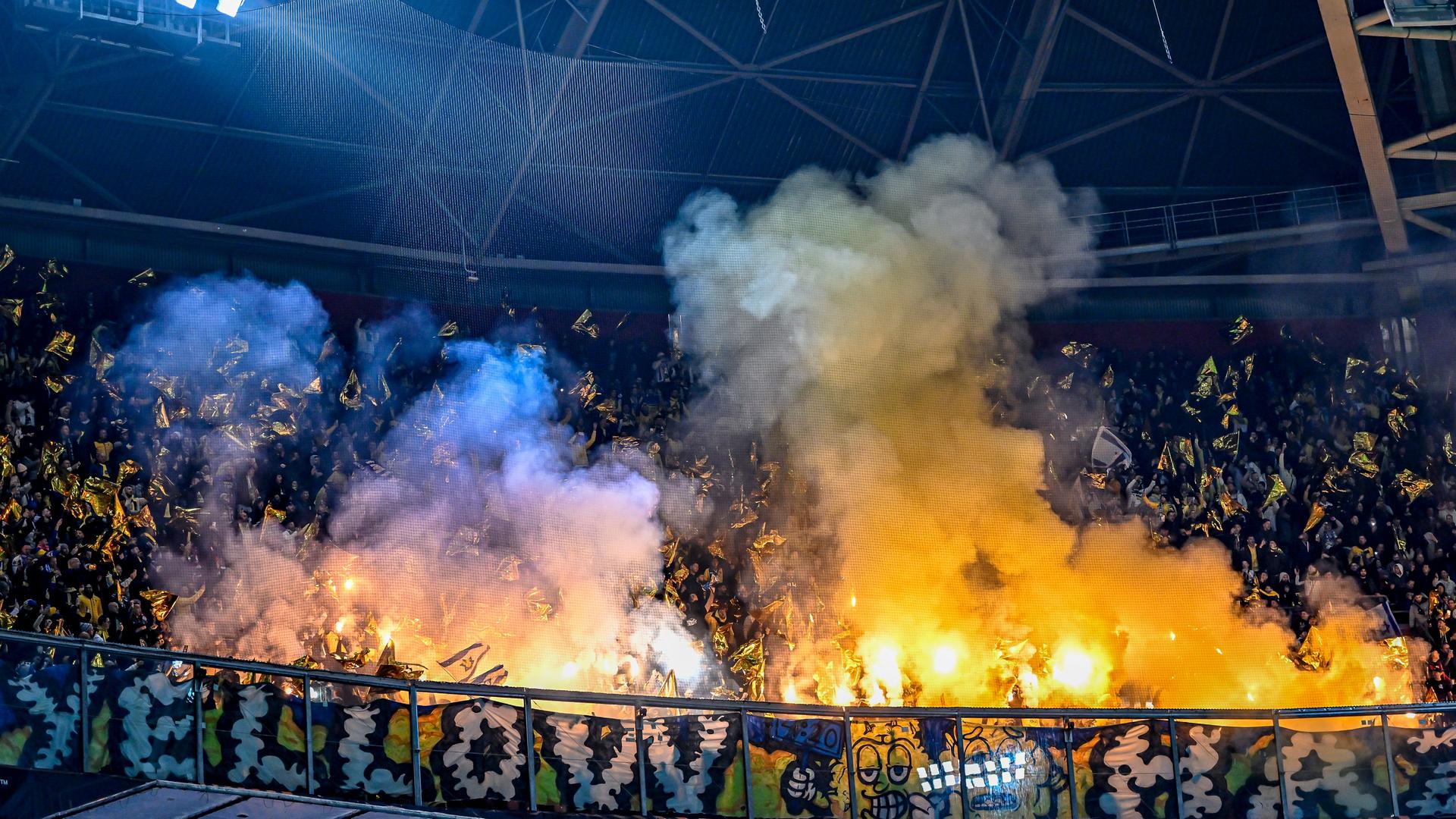 Fans of the Israeli football club Maccabi Tel-Aviv set off pyrotechnics during a game in Amsterdam.