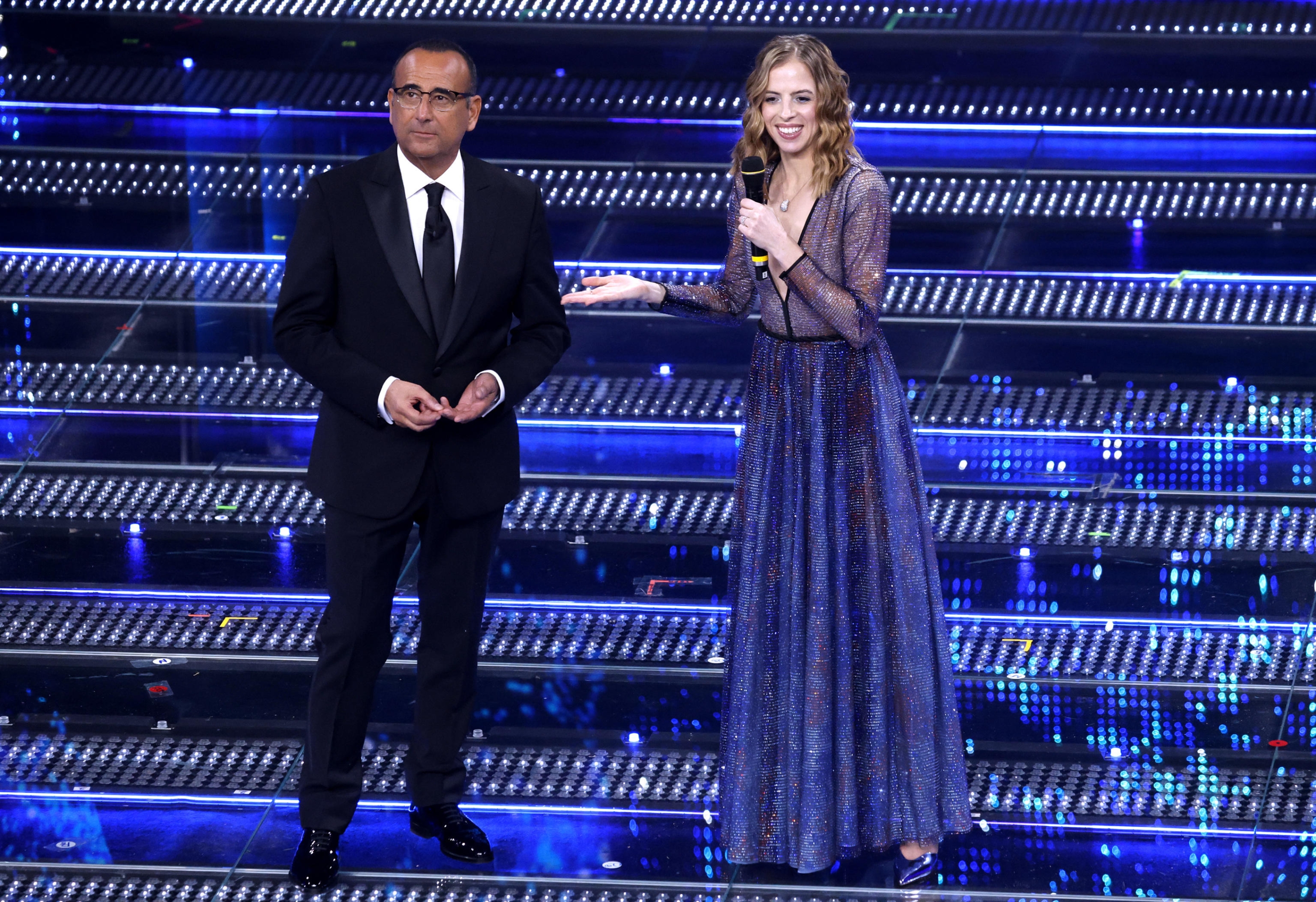Sanremo Festival Host and Artistic Director Carlo Conti and Formers Italian Figure Skater Carolina Kostner on Stage at the Ariston Theater During the 75th Edition of the Sanremo Italian Song Festival, in Sanremo, Italy, 12 Febreny 2025. The Music Festival Will Run FROM 11 to 15 Febration 2025. ANSA/FABIO CLUTACI