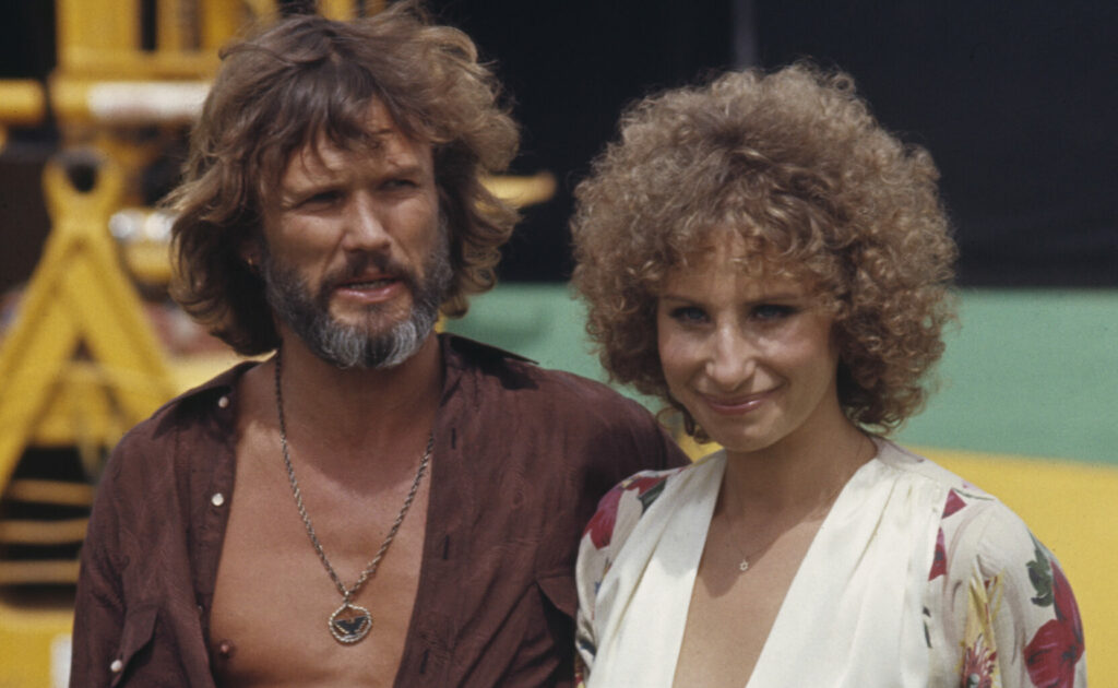 Kris Kristofferson (1936-2024) and Barbra Streisand during a break from the shoot "A Star is Born"