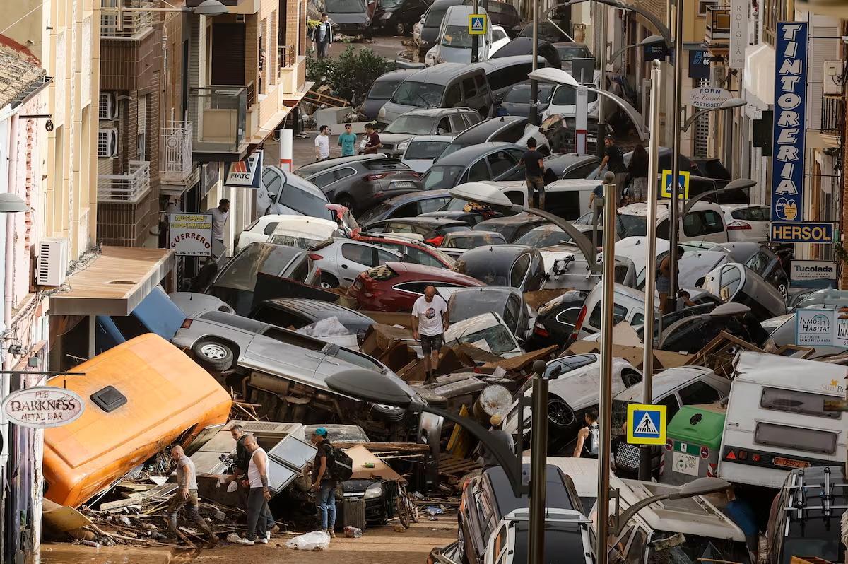 Vehículos amontonados en una calle tras las intensas lluvias de la dana, este miércoles en Sedaví (Valencia).