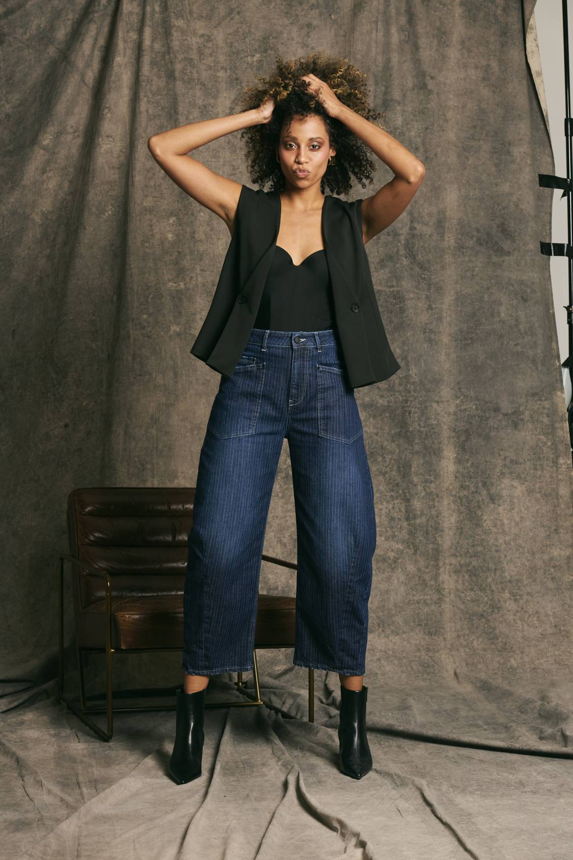 '94odina' denim with patrol and black vest.