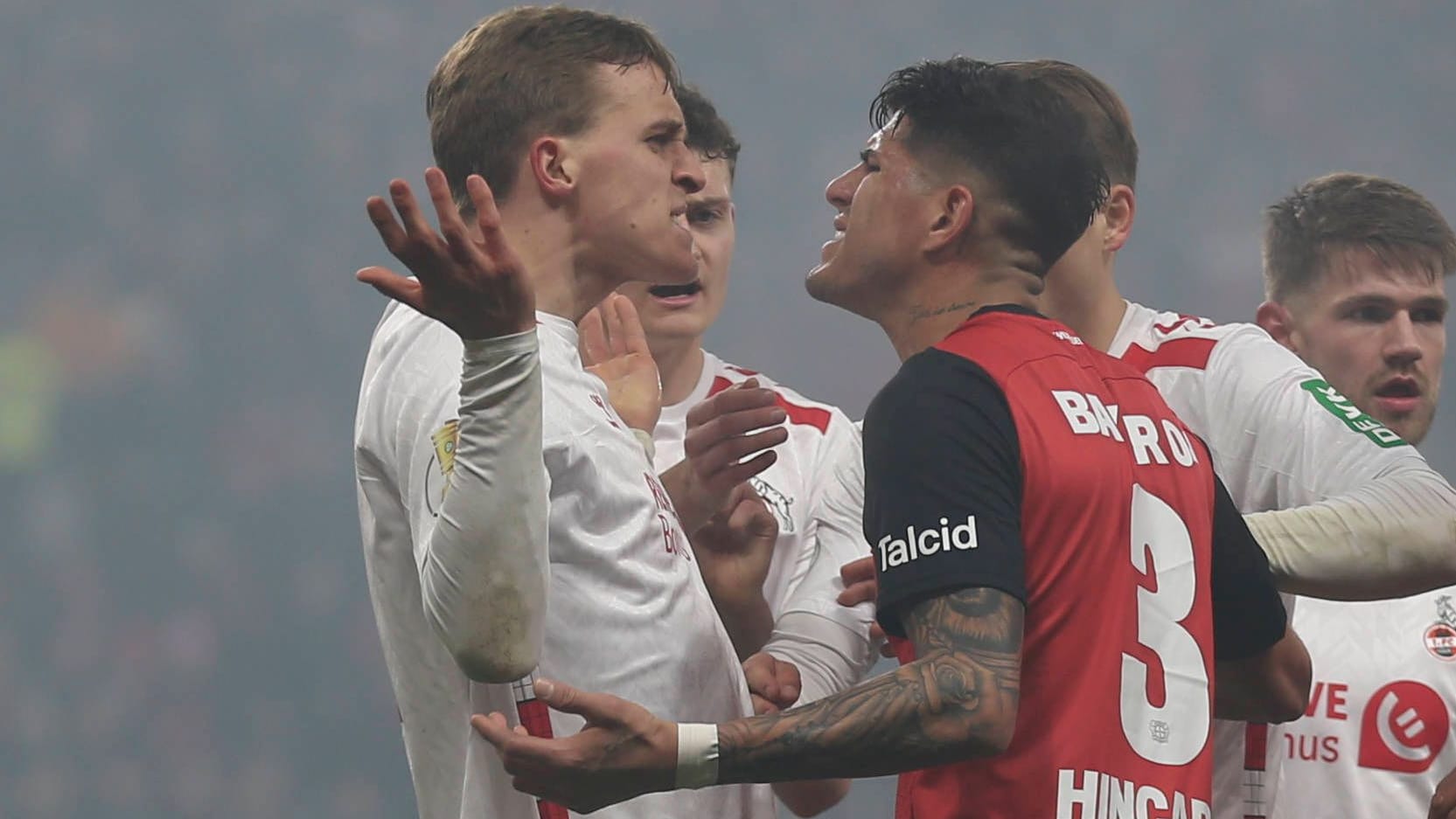 Emotional: Cologne Hübers (left) and Leverkusens Hincapie in the DFB Cup quarter-finals.