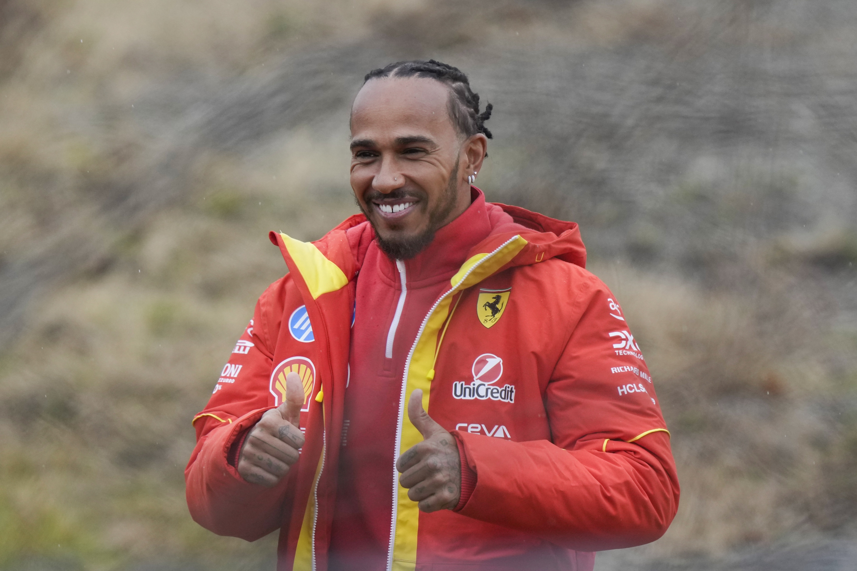 British Driver Lewis Hamilton Cheers Ferrari Fans Gathered Outside The Track, After testing in Ferrari Formula One SF-23, in Fiorano Modenese, Italy, Wednesday, Jan.22, 2025. (AP Photo/Luca Bruno)