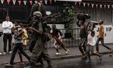 A heavily armed warrior of the M23 militia walks on the street in Goma.  