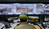 A police officer looks at camera images of the crowd. Photo Niharika Kulkarni/AFP  