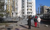 Residents of the Ukrainian city of Odesa view the damage to a residential building and a clinic for children caused by a Russian drone attack on Wednesday. At least four people were injured, including a child.