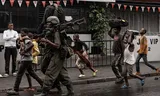 A heavily armed warrior of the M23 militia walks on the street in Goma.  