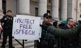 A demonstrator holds up a protest board at the New York court, where there is a hearing about the arrest of Mahmoud Khalil.