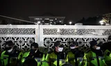Police officers at the gate of the parliament building, after the South Korean President Yoon Suk-Yeol announced the state of emergency.