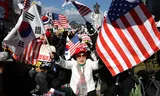 Supporters of the suspended President Yoon are waving in Seoul with South Korean and American flags. Many protesters believe in conspiracy theories about election fraud. 
