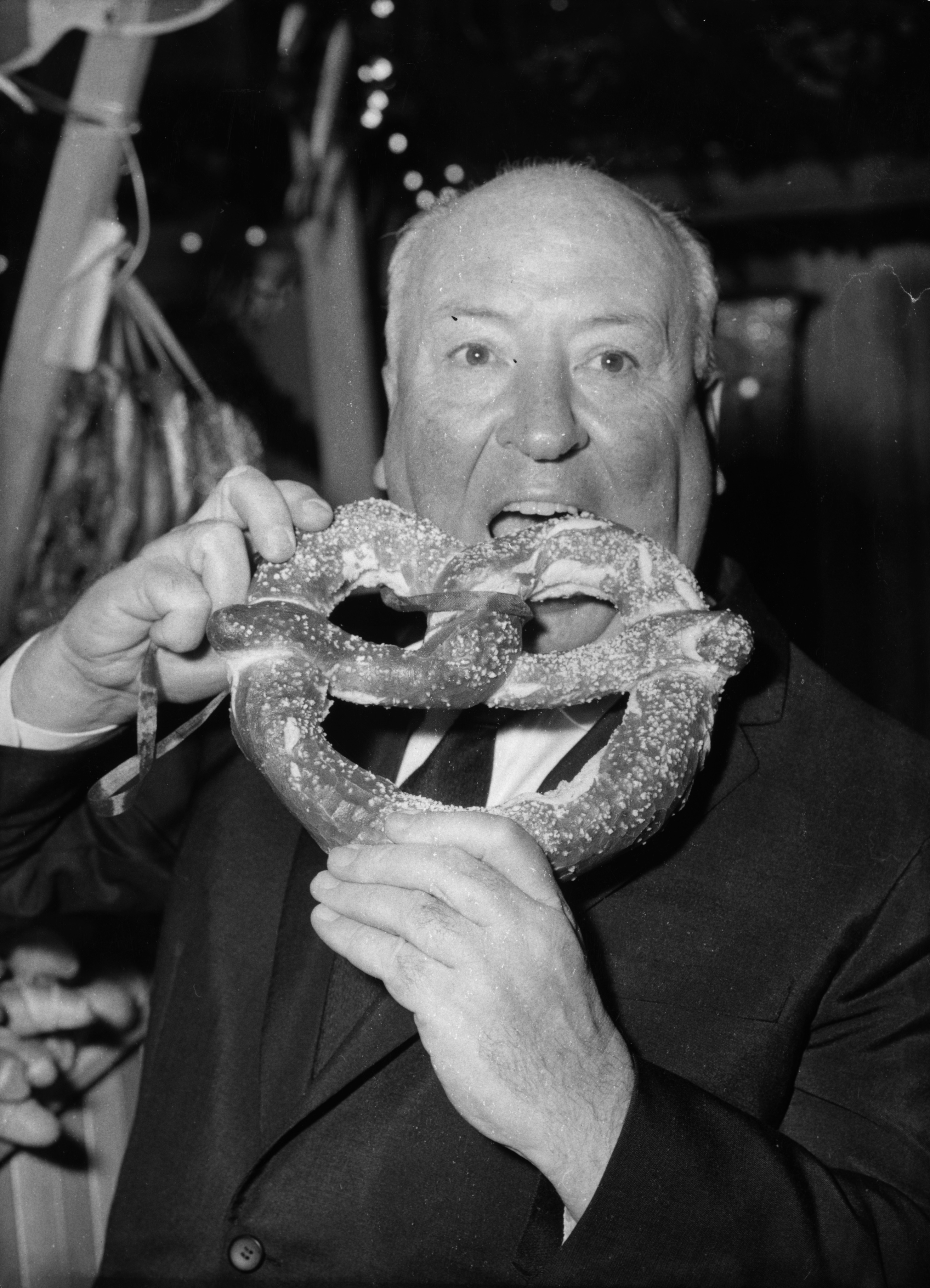 Hitchcock bites into a pretzel