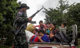Members of the Karenni rebel group KNDF bring citizens to safety during the battle for Loikaw, November 2023.   