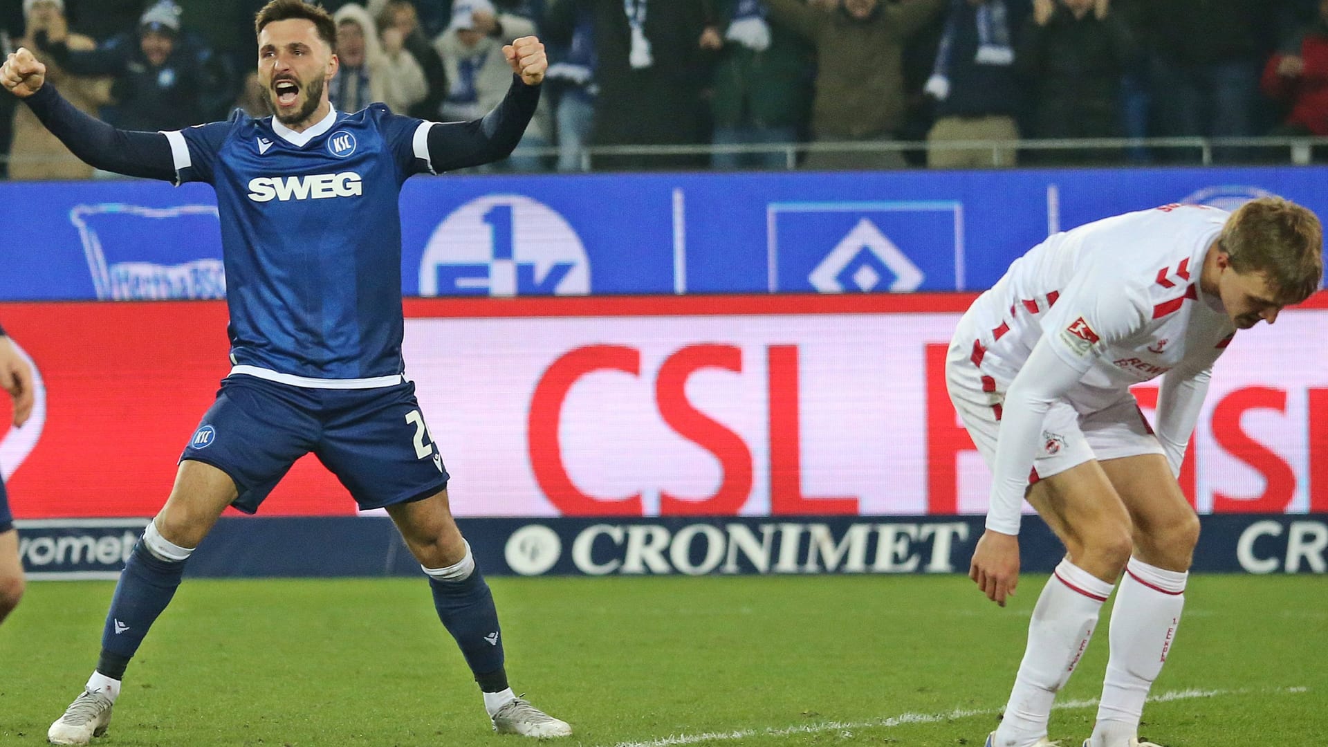 Freud and suffering: Karlsruhes Schleusener (left) cheers, Cologne's own goal scorer Hübers cannot believe.