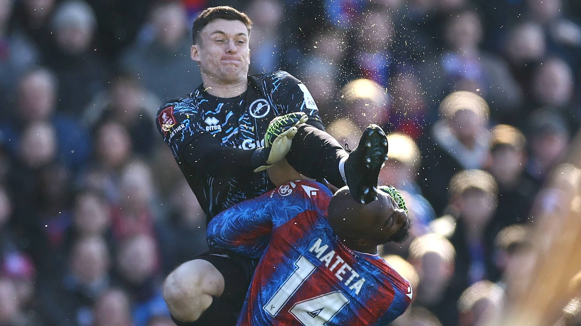 Fully hit: Millwall's goalkeeper Roberts (left) against Crystal Palace player Mateta.