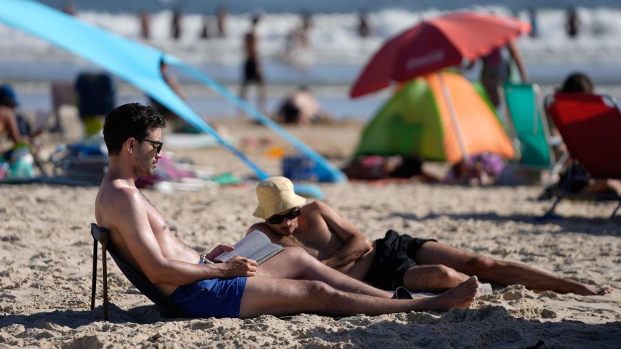 Photo galleria tourists read books on the south beach, in Cabo Polonio, in the department of Rocha, Uruguay
