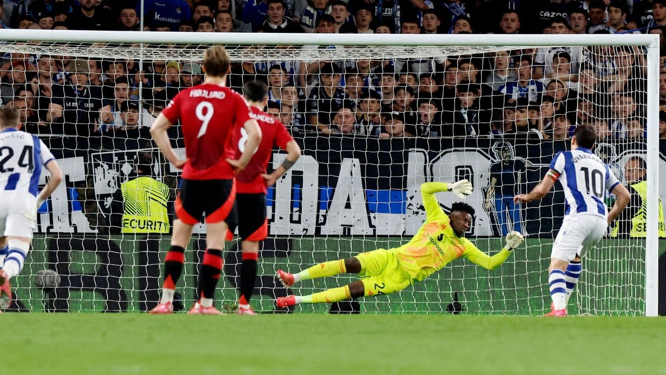 The compensation: Real Sociedads Mikel Oyarzabal (right) hits United keeper Onana.