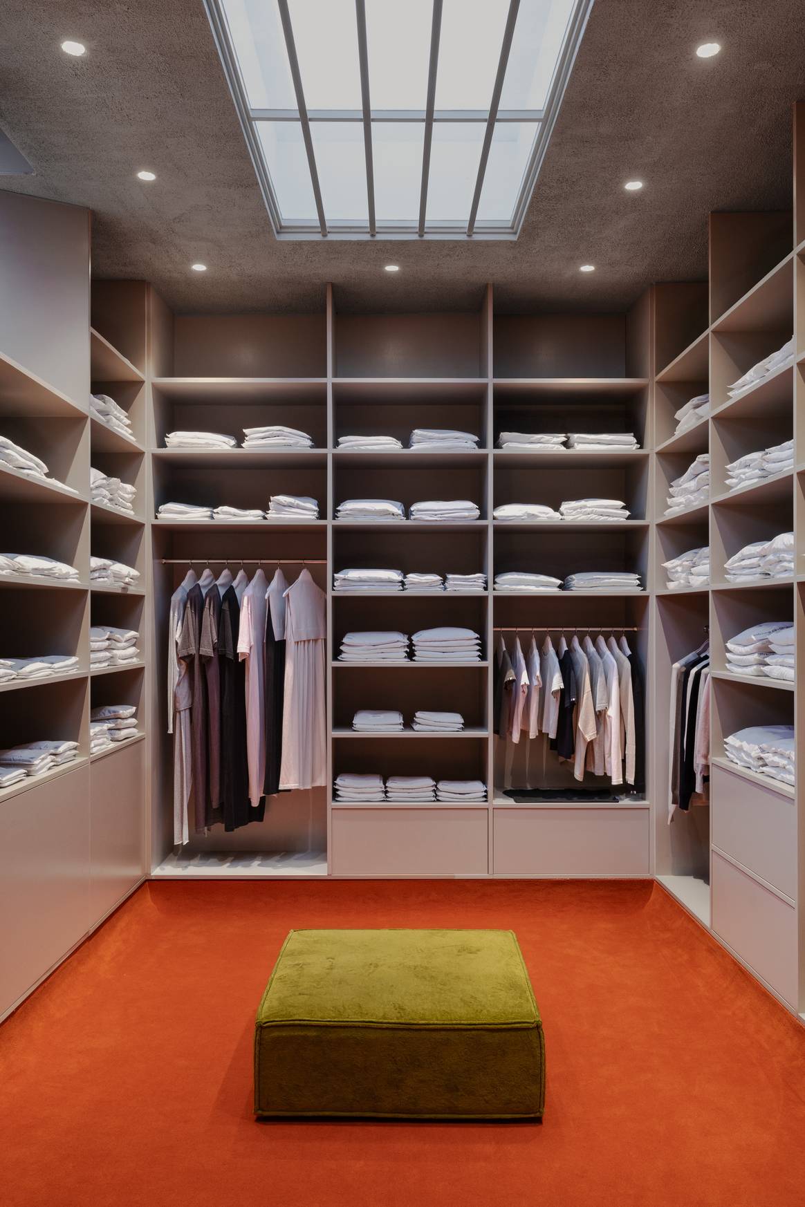 At the very back you will find: woman the room with clothes.