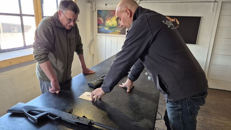 Together with the owner of the shooting range, Wim looks at what he has touched (photo: Niek de Bruijn).