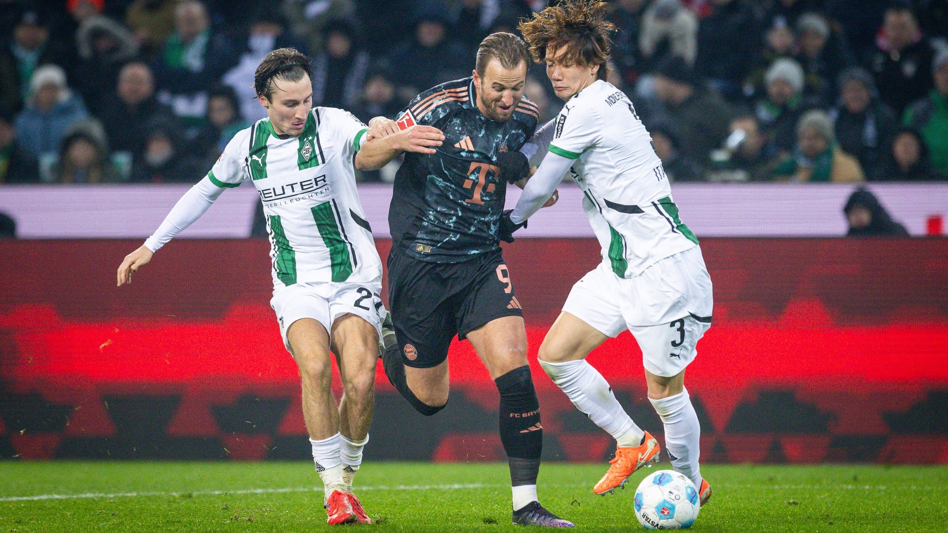 Next season in the same team? Gladbach's ItaKura (right) in a duel with Bayern scorer Harry Kane.