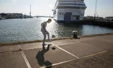 A resident plays football at the large refugee ship Silja Europe on Marconistraat, Rotterdam. The ship is used to place refugees with residential status in the Netherlands. 