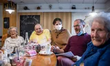 Residents of the home together with the director and an employee. 