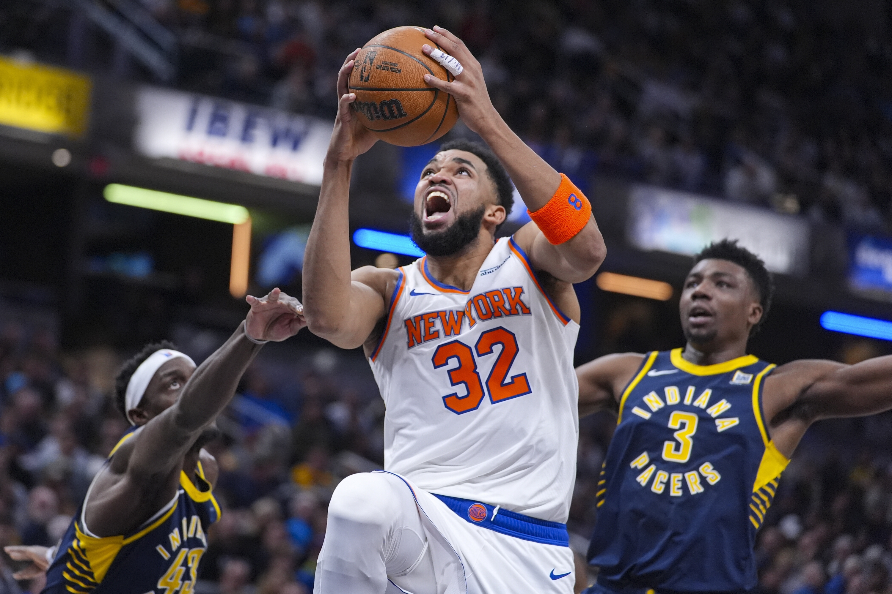 New York Knicks Center Karl-Anthony Towns (32) Shoots Bethaeen Indiana Pacers Forward Pascal Siakam (43) and Center Thomas Bryant (3) During the First Half of an NBA Basketball Game in Indianapolis, Tuesday, Feb. 11, 2025. (AP Photo/Michael Conroy)