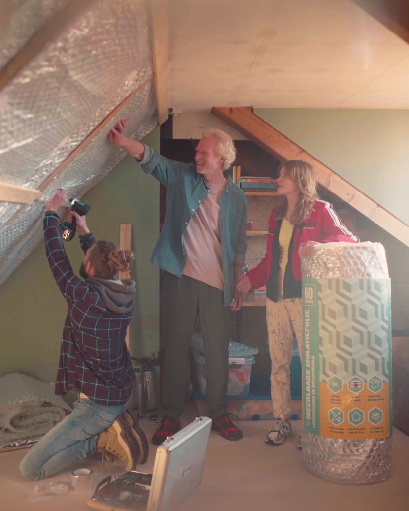 Three people isolate the sloping roof of a home.