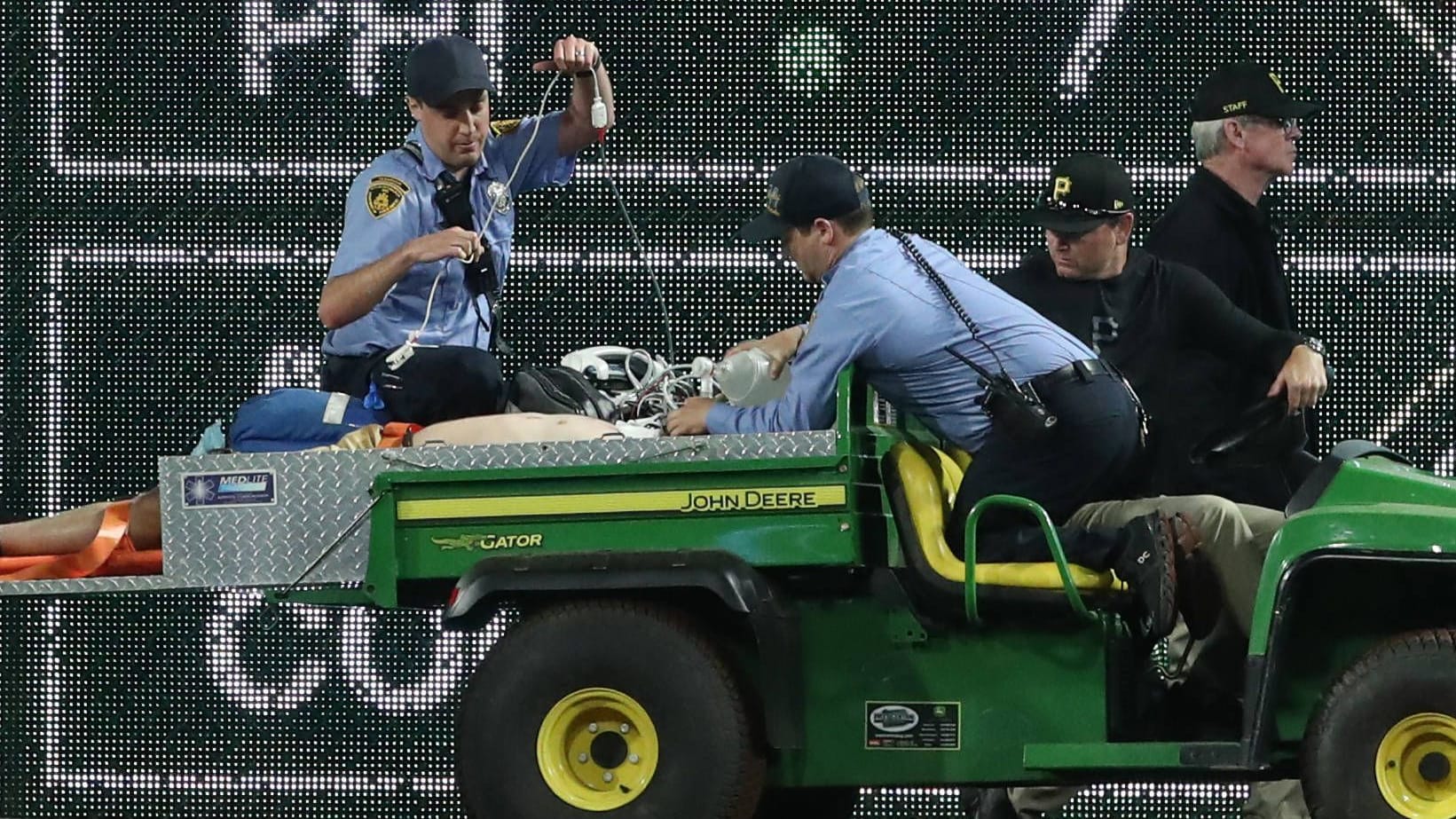 A fan is driven off the pitch: the incident caused a game interruption.