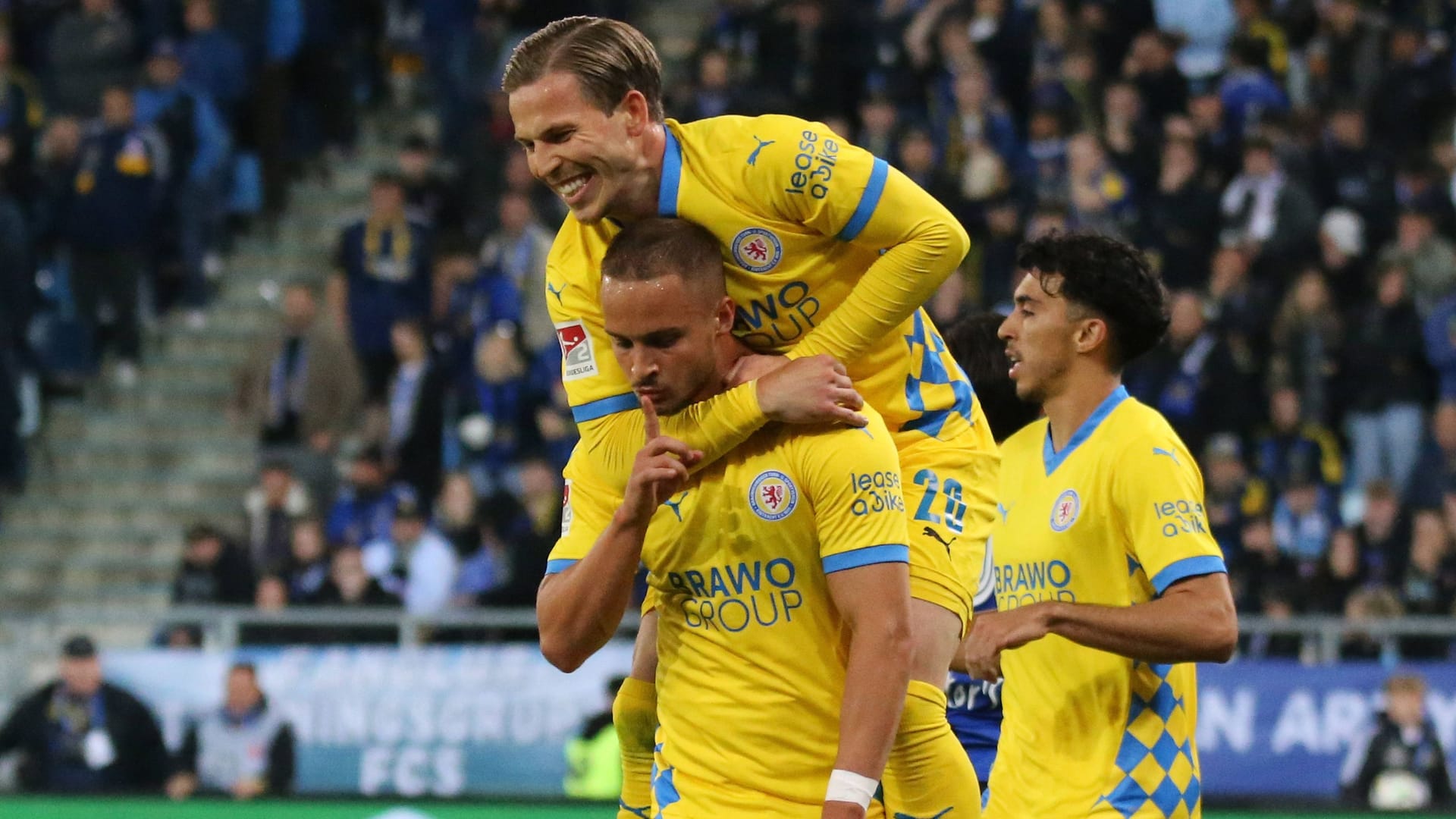 The decision: Braunschweig's scorer Rittmüller (below) is celebrated after the 2-0.