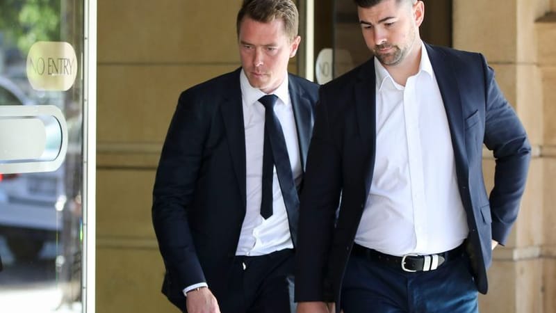 Rohan Dennis (left) leaves the Sir Samuel Way Building in Adelaide.