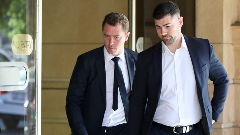 Rohan Dennis (left) leaves the Sir Samuel Way Building in Adelaide.