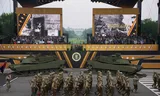 President Donald Trump and guests see American soldiers march past.