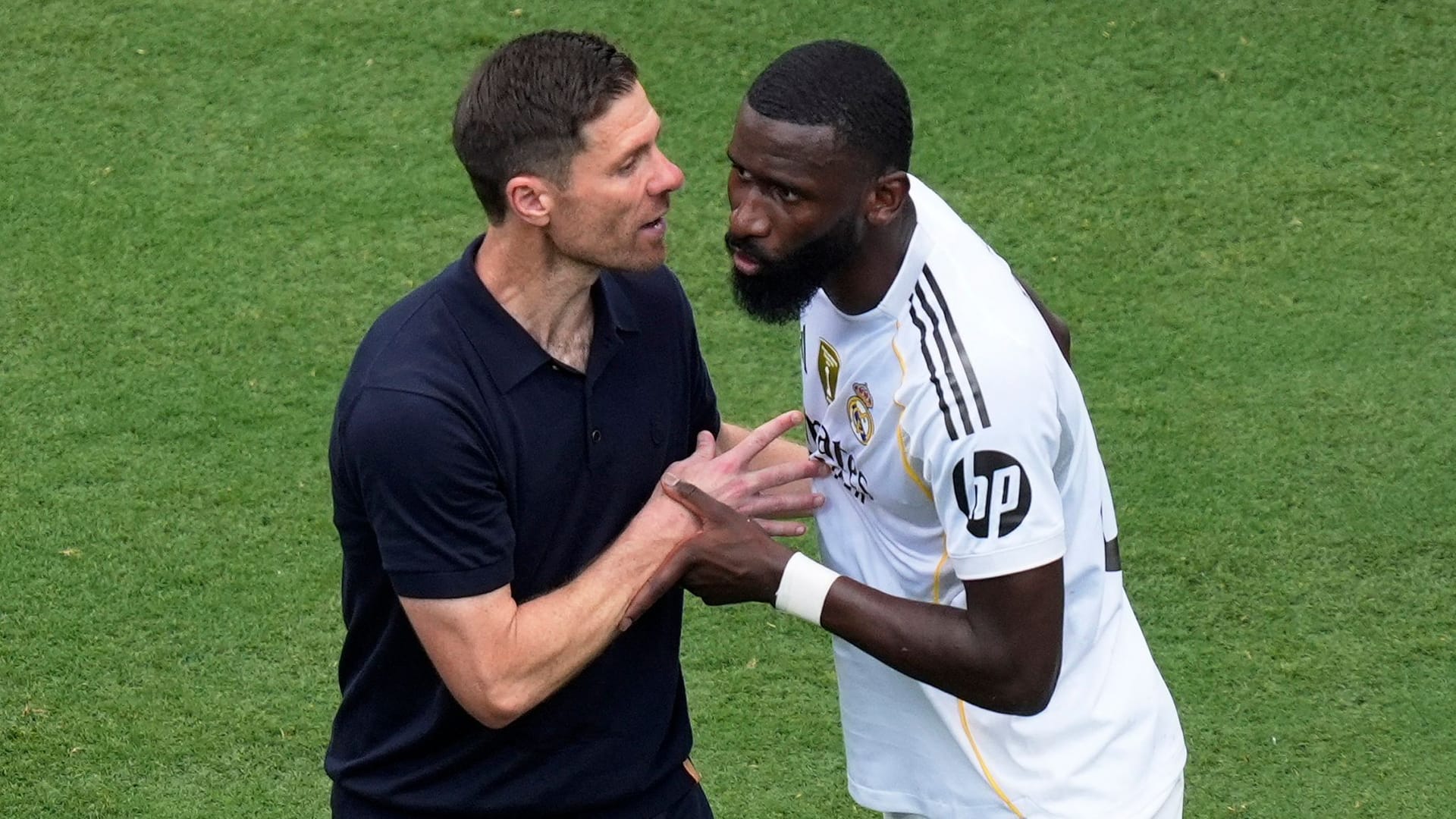 Relieved: Real coach Alonso (left) with defender Rüdiger.