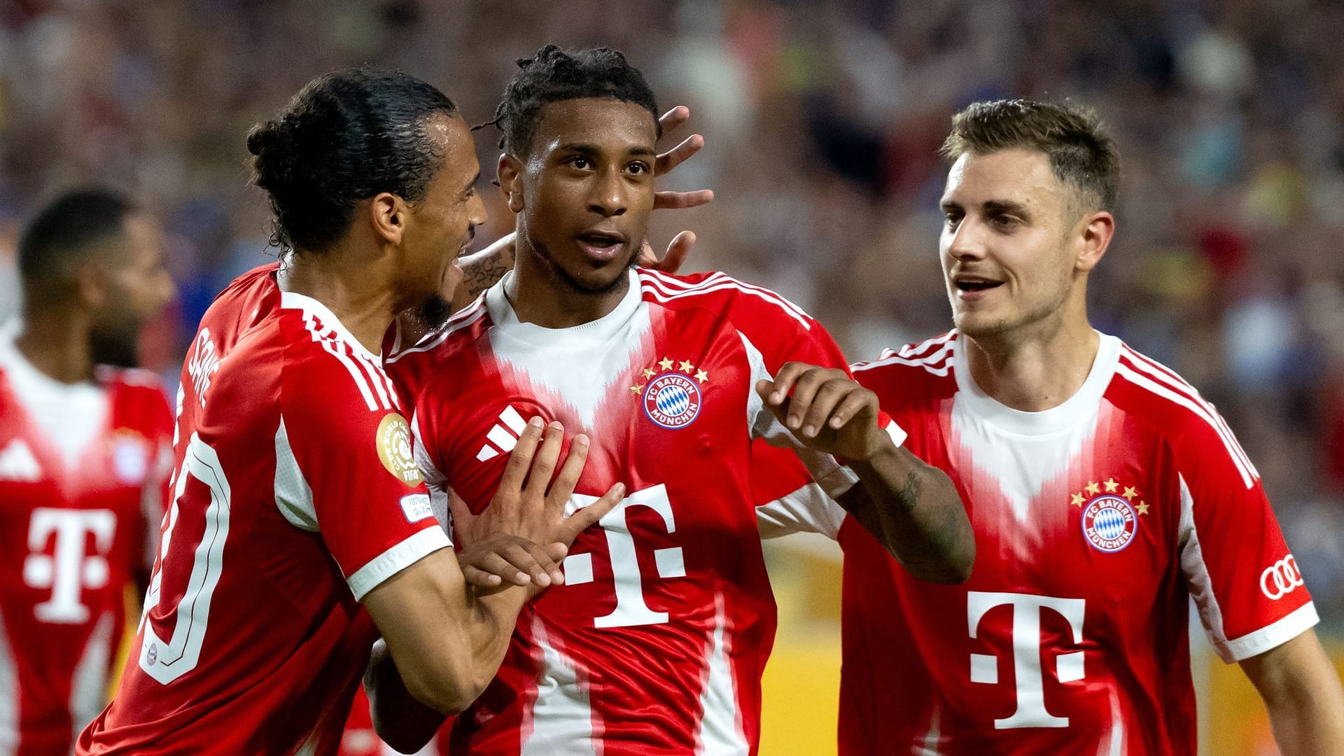 Leroy Sane (LR), Michael Olise and Josip Stanisic from Munich cheer on Olise's winning goal for 2-1.