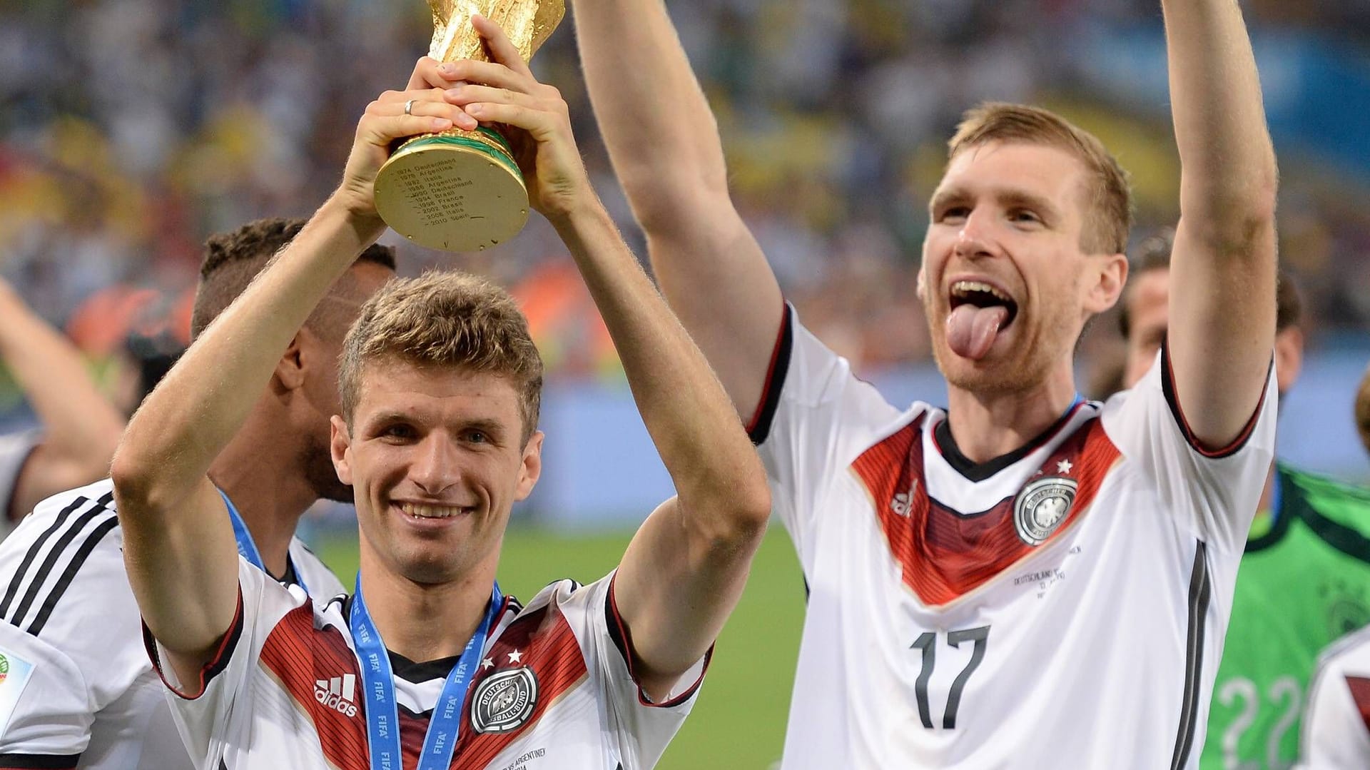 Per Mertesacker (right) alongside Thomas Müller: The central defender played at Arsenal at the time of the World Cup victory.