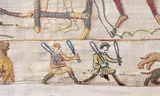 The issue is whether or not the running man on the right has dangling penis under his tunic. Photo: Bayeux Museum