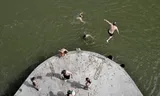 Swimmers in Nijmegen. People jump from a pillar of the railway bridge, although it is forbidden to swim there.