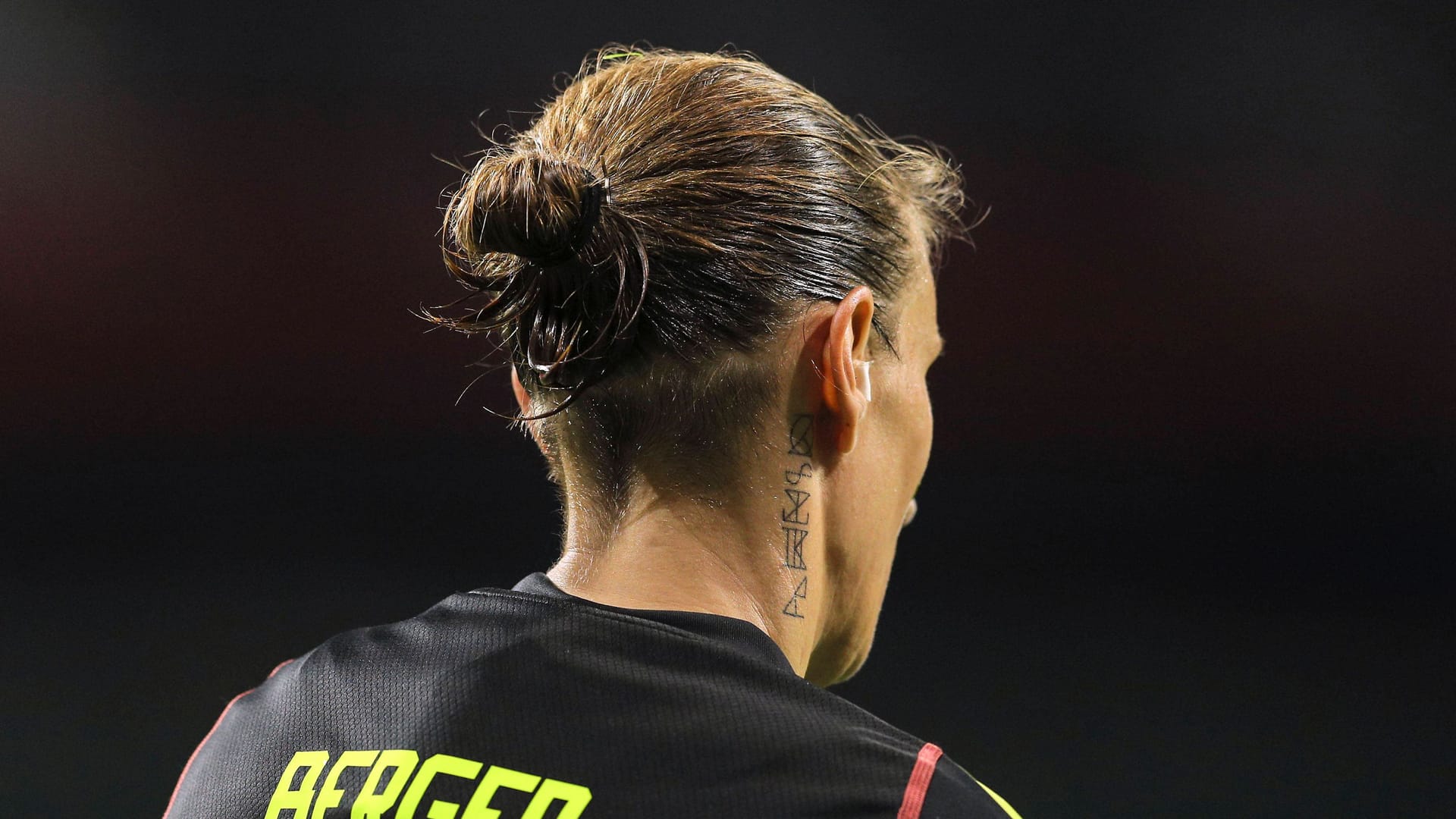 Here you can see the tattoo behind the right ear of Ann-Katrin Berger.