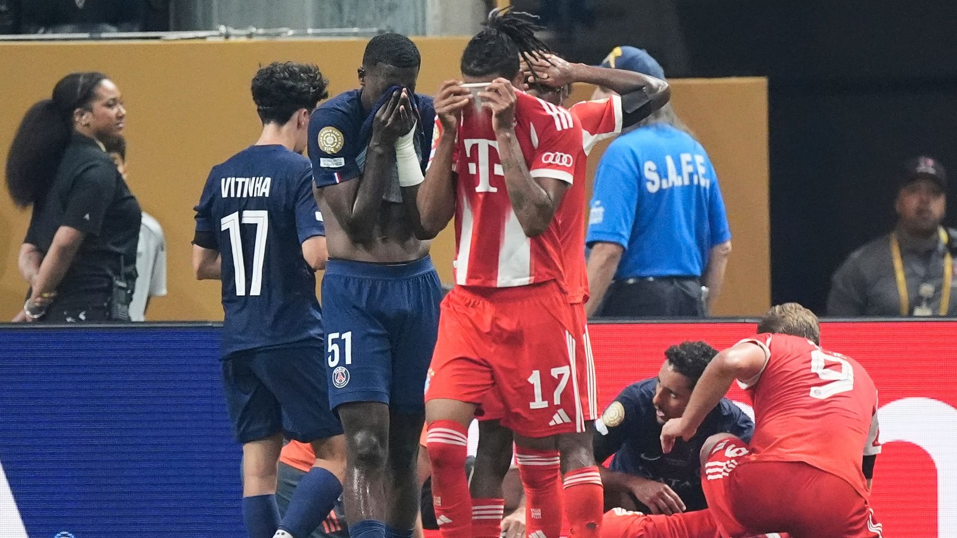 Bavaria's Michael Olise reacts to the injury of his team -mate Jamal Musiala.